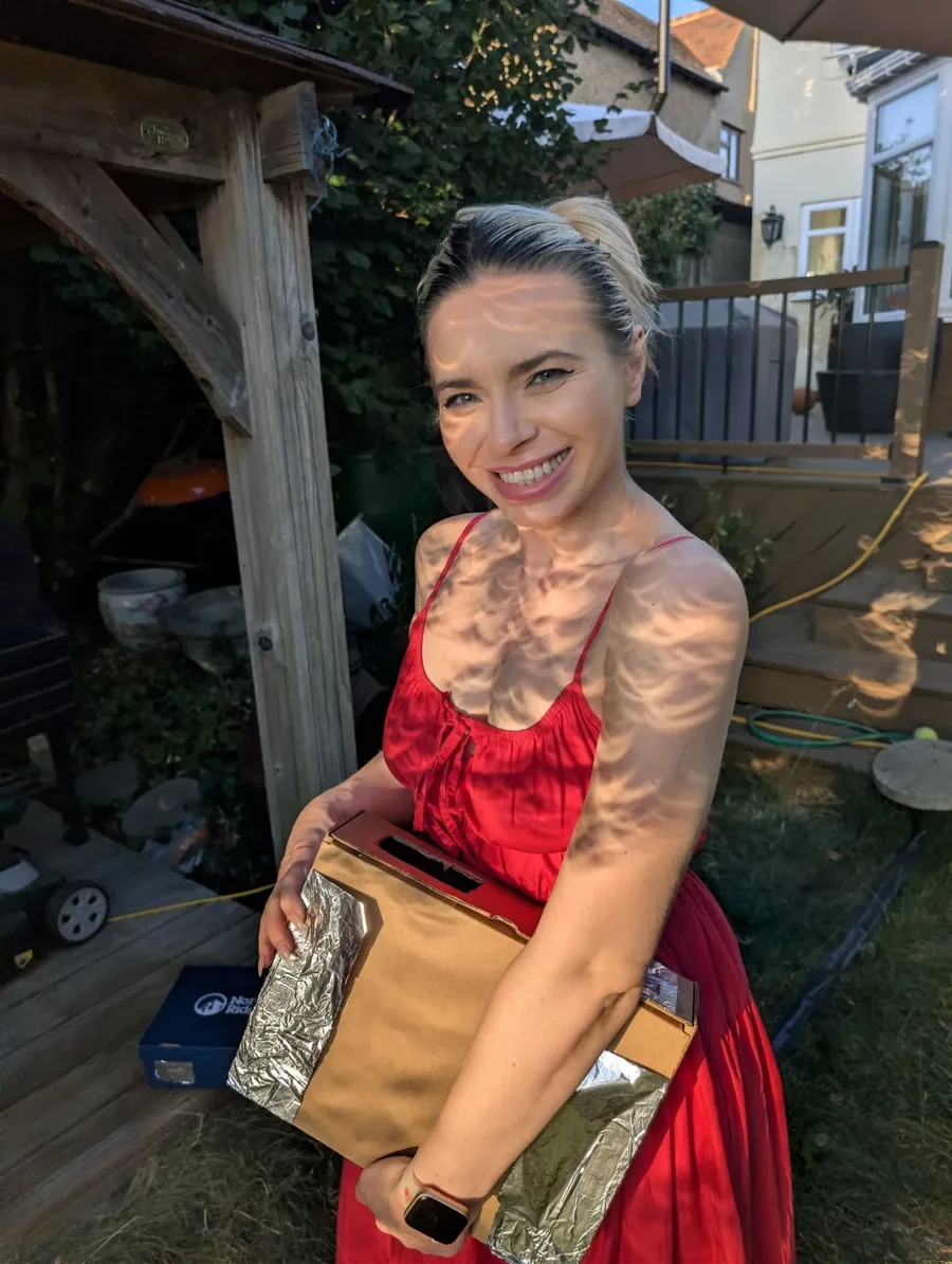 Holding a finished piece outside the studio