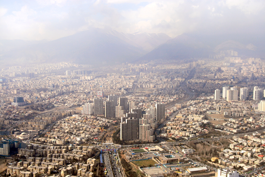 The city spread out below the mountains in haze