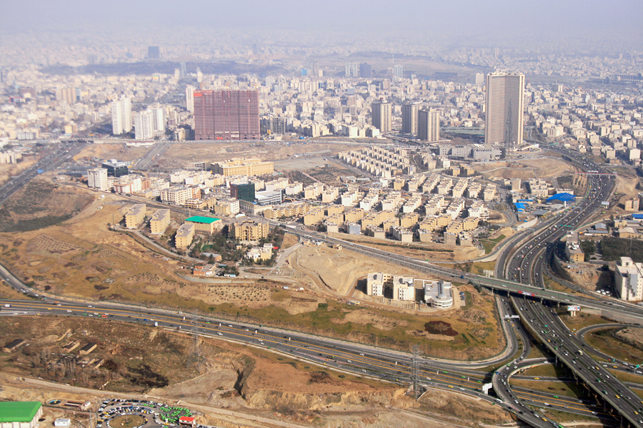 The city from above: apartment blocks, low houses and a highway running through