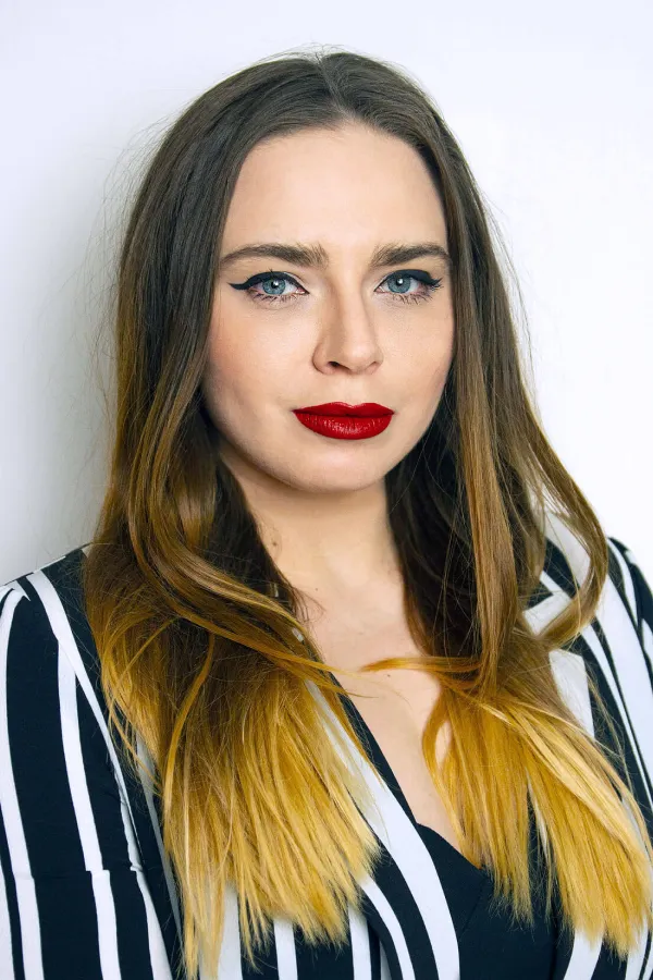 Portrait of a woman with long hair in a striped top