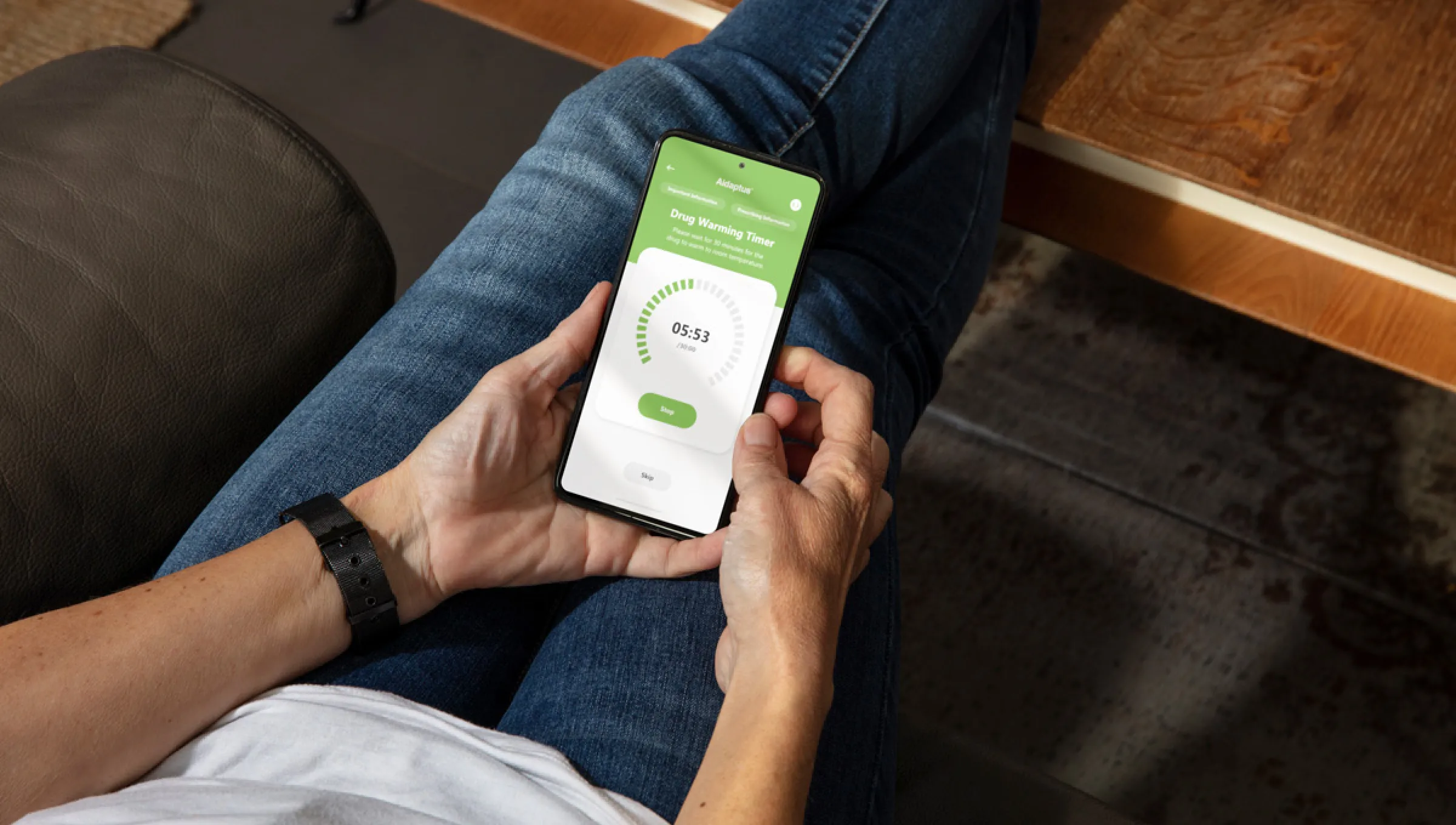 man looking at mobile with aidaptus app