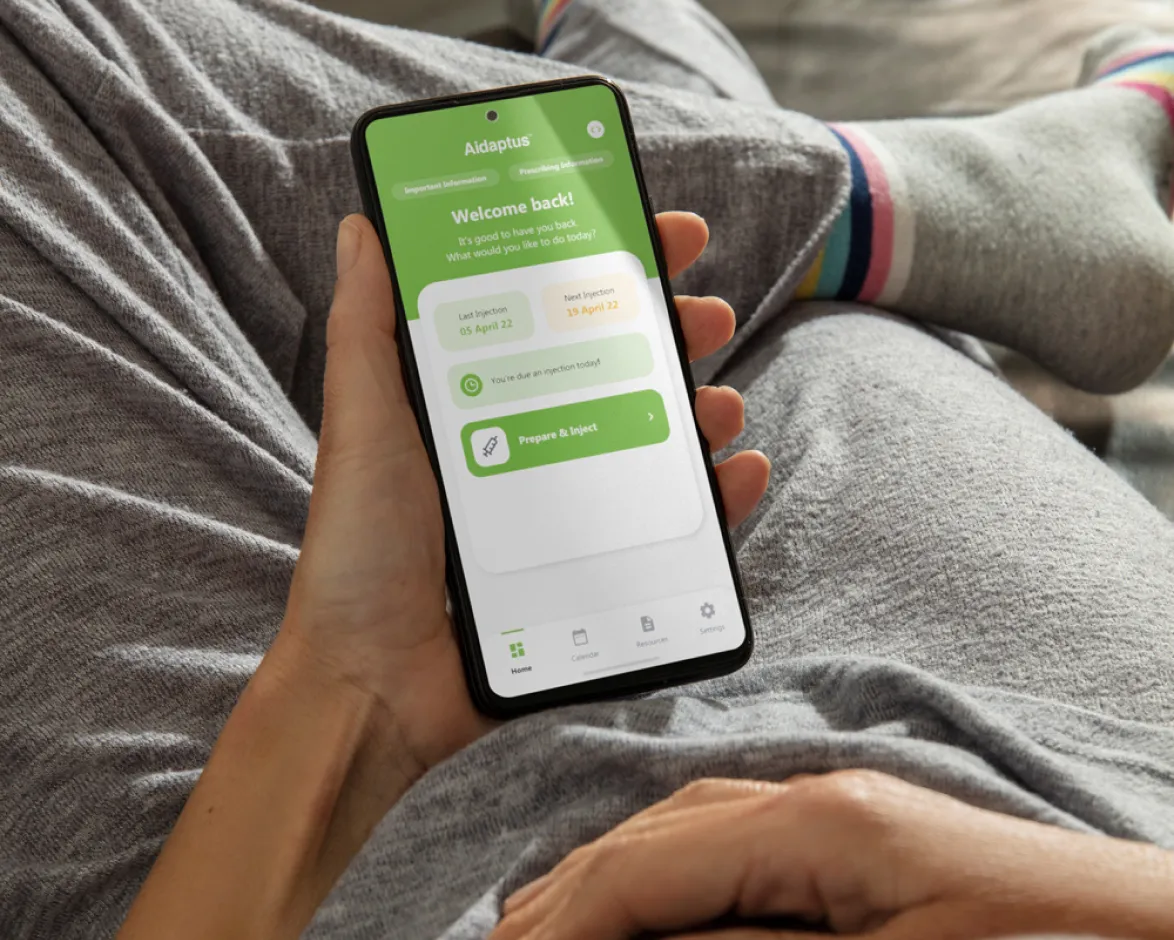 man looking at mobile with aidaptus app